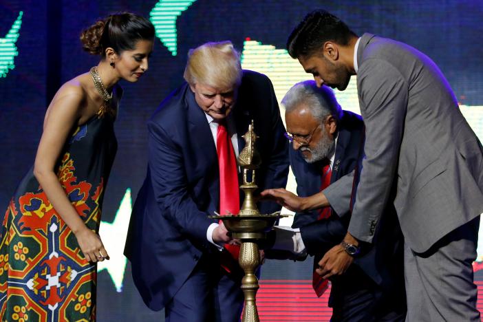 republican hindu coalition chairman shalli kumar 2nd r helps republican presidential nominee donald trump 2nd l light a ceremonial diya lamp photo reuters