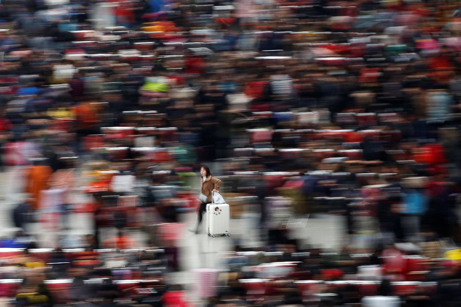 Passengers wait to board trains at Shanghai's Hongqiao Railway Station as hundreds of millions of Chinese travel home for Lunar New Year in Beijing and Shanghai, in Shanghai, China. PHOTO: REUTERS