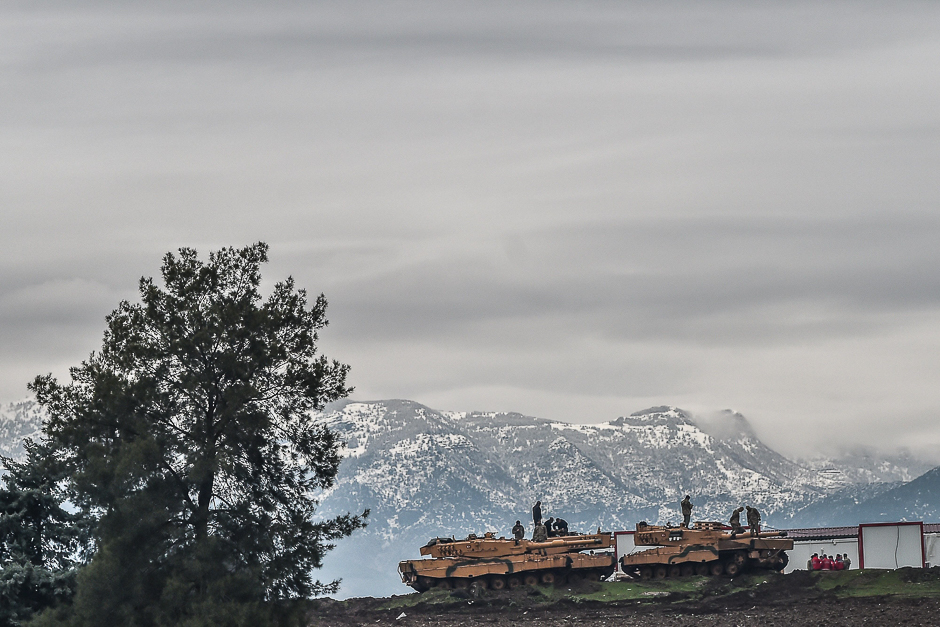 Turkish tanks are parked near the Syrian border at Hassa, in Hatay province as part of the operation 