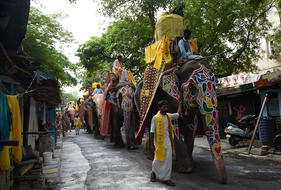 Indian devotees ride decorated elephants as they take part in the Lord Jagannath Jal Yatra in Ahmedabad. PHOTO: AFP