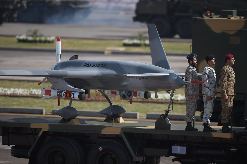 Military personnel stand beside a drone on a transporter during a Pakistan Day military parade in Islamabad. PHOTO: AFP