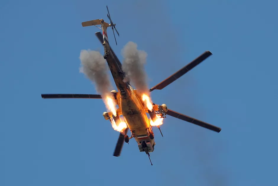 an iraqi airforce helicopter fires missiles at islamic state fighters at the outskirts of mosul iraq photo reuters
