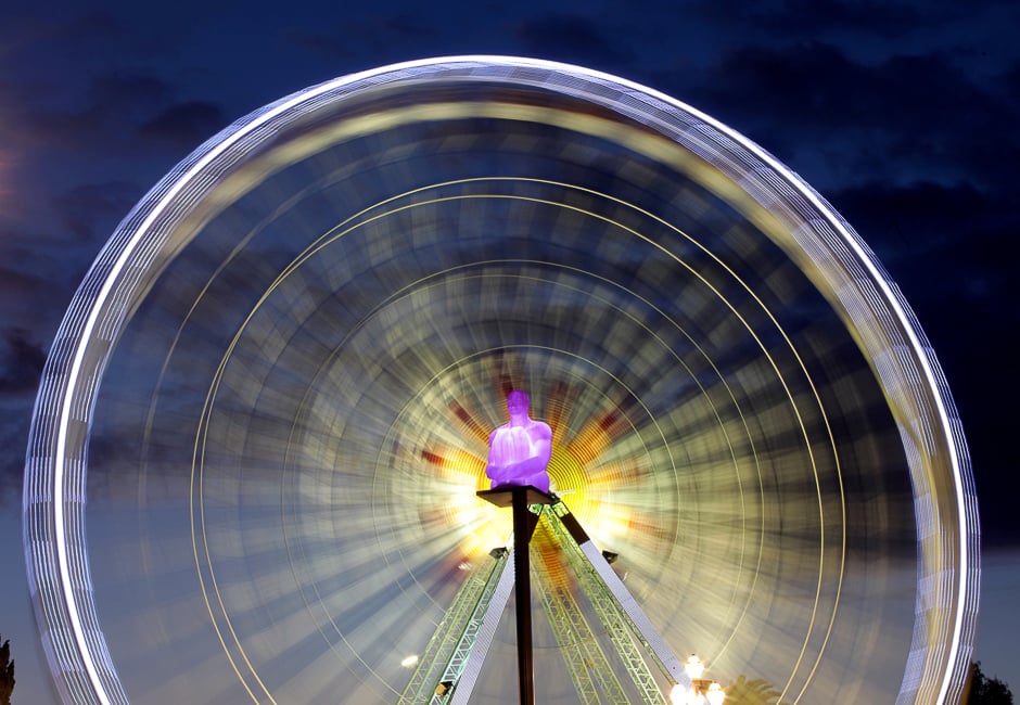 A ferris wheel is seen behind one of the seven statues by Spanish artist Jaume Plensa at Massena square in Nice, France. PHOTO: REUTERS