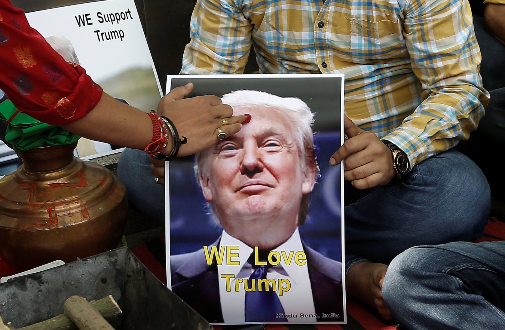 a priest applies a quot tika quot on the portrait of republican us presidential candidate donald trump during a special prayer organised by hindu sena photo reuters