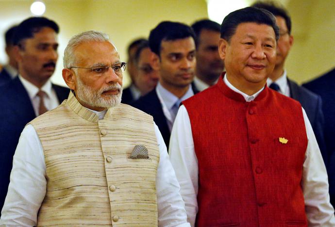 indian prime minister narendra modi l and chinese president xi jinping arrive for a photo opportunity ahead of brics brazil russia india china and south africa summit in benaulim in the western state of goa india october 15 2016 photo reuters