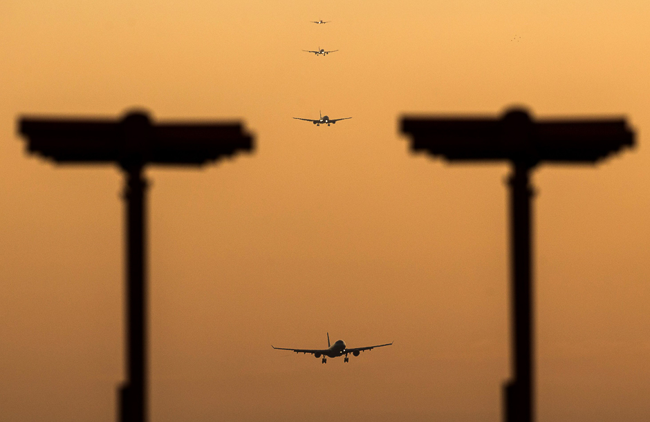 passenger aircraft prepare to land during sunrise at london heathrow airport in west london photo afp