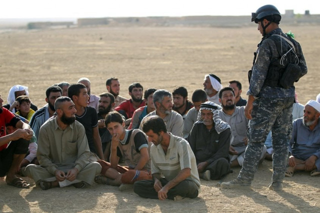 displaced iraqis from the bajwaniyah village about 30 kms south of mosul who fled fighting in the mosul area gather as iraqi security forces enter the village on october 18 2016 after they liberated it from islamic state is group extremists photo afp displaced iraqis from the bajwaniyah village about 30 kms south of mosul who fled fighting in the mosul area gather as iraqi security forces enter the village on october 18 2016 after they liberated it from islamic state is group extremists photo afp