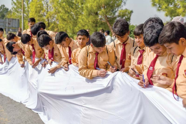 students signing a white flag photo express students signing a white flag photo express