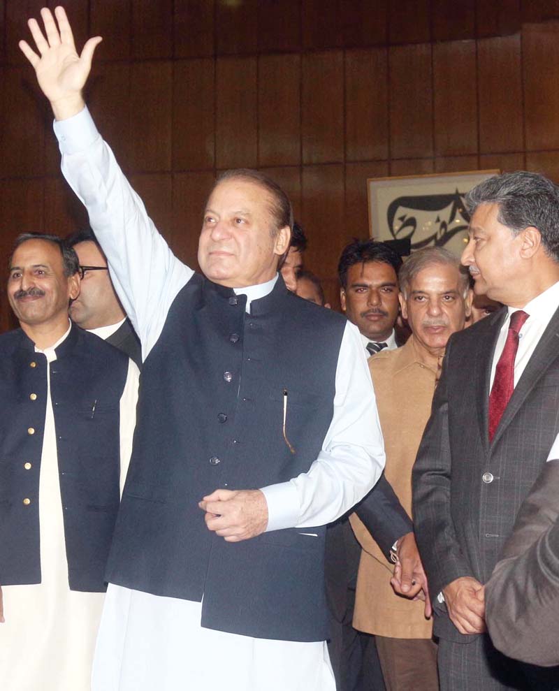 pm nawaz waves to party members at the intraparty polls photo inp