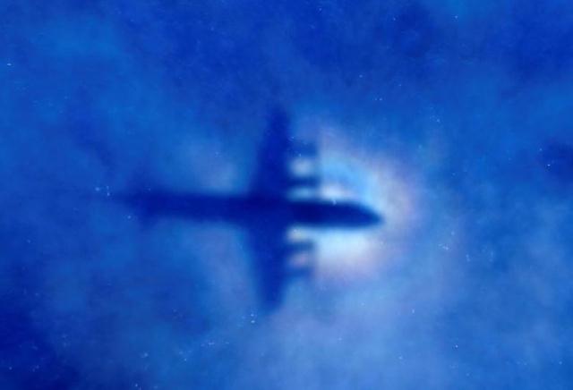 file photo the shadow of a royal new zealand air force rnzaf p3 orion maritime search aircraft can be seen on low level clouds as it flies over the southern indian ocean looking for missing malaysian airlines flight mh370 march 31 2014 photo reuters