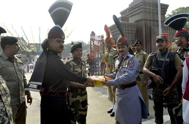 pakistani ranger commander shaukat ali 2r presents sweets to indian border security force bsf commandant sudeep 3l during a ceremony to celebrate pakistan s independence day at the pakistan india wagah border post on august 14 2016 photo afp