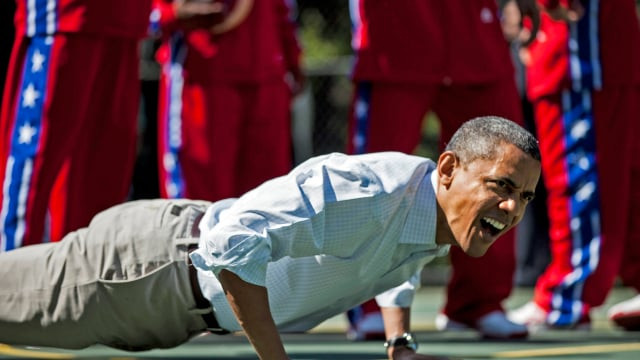 us president barack obama does pushups during backetball shooting drills during the annual easter egg roll on the south lawn of the white house april 9 2012 in washington dc the first family participated in the yearly event where the south lawn is opened up to guests to participate in various egg rolls and other activities photo afp