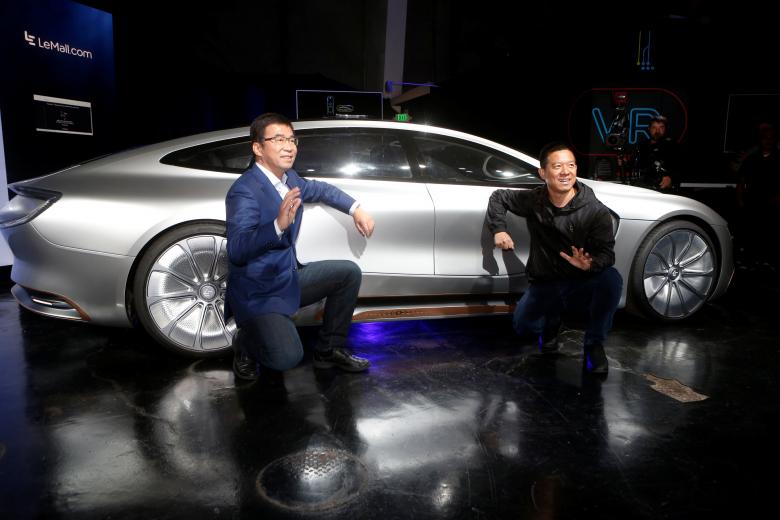 leeco ceo and founder yt jia r and co founder and global vice chairman lei ding pose in front of a lesee car photo reuters