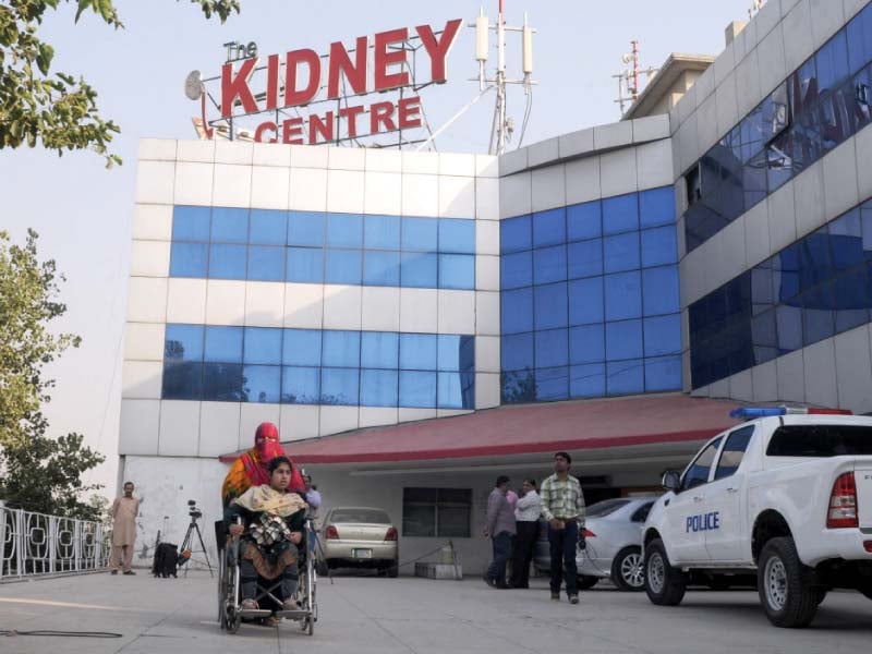 a woman takes a patient from kidney centre as police sealed the health facility on jhelum road photo waseem nazir express