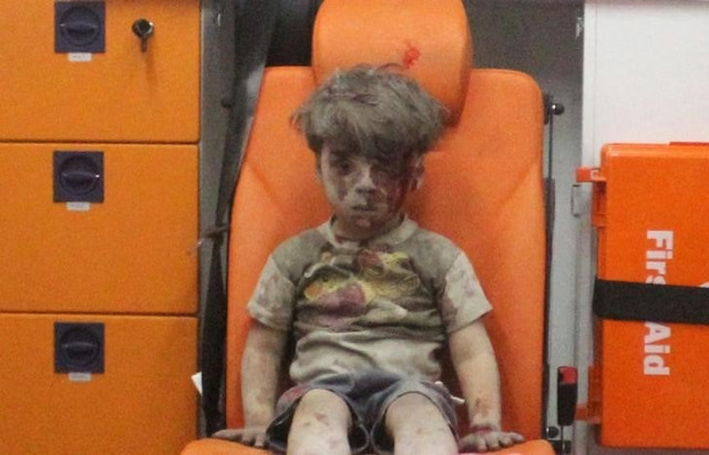 the very real picture of 5 year old omran daqneesh with bloodied face sits inside an ambulance after he was rescued following an airstrike in the rebel held al qaterji neighborhood of aleppo photo reuters the very real picture of 5 year old omran daqneesh with bloodied face sits inside an ambulance after he was rescued following an airstrike in the rebel held al qaterji neighborhood of aleppo photo reuters