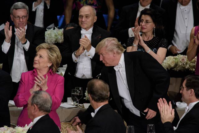 republican presidential nominee donald trump moves democratic presidential nominee hillary clinton 039 s chair during the alfred e smith memorial foundation dinner at waldorf astoria october 20 2016 in new york photo afp