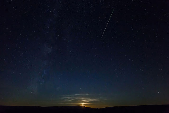 this picture shows a perseid meteor along the milky way illuminating the dark sky near pesquera de ebro in the province of burgos northern spain during the 039 perseids 039 meteor shower photo afp