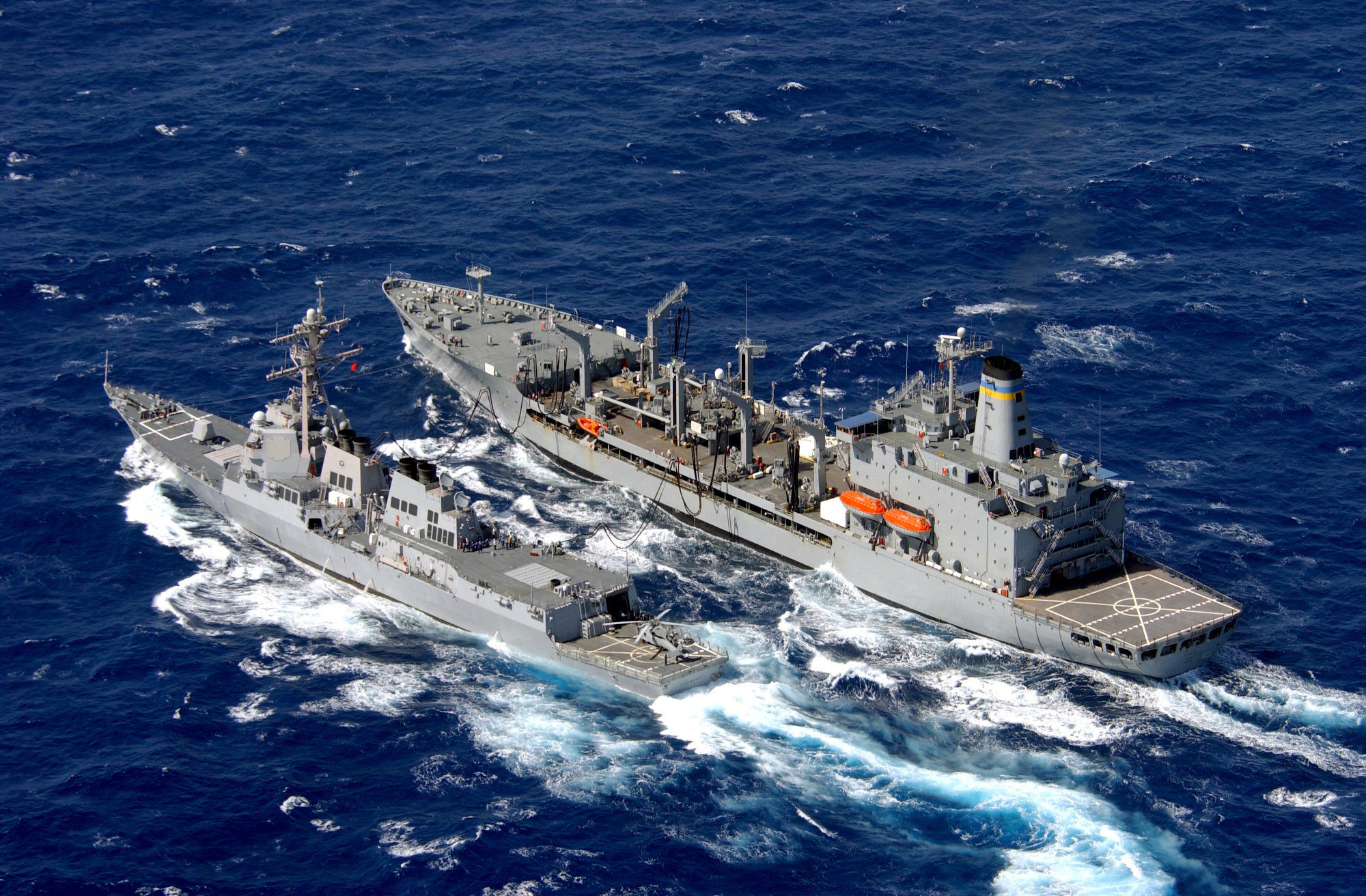 aerial starboard side view showing the us navy usn arleigh burke class flight iia guided missile destroyer aegis uss decatur ddg 73 left conducting replenishment at sea ras operations with the usn military sealift command msc henry j kaiser class oiler usns pecos t ao 197 while underway in the pacific ocean