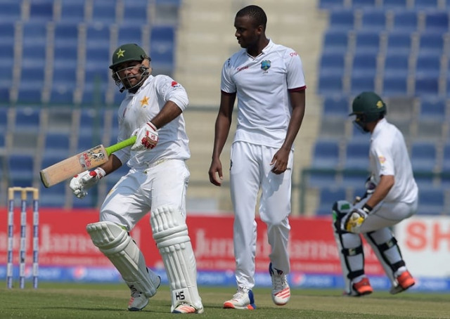 pakistani batsman sarfraz ahmed l takes run next to the west indies 039 bowler miguel cummins on the second day of the second test between pakistan and the west indies at the sheikh zayed cricket stadium in abu dhabi on october 22 2016 photo afp