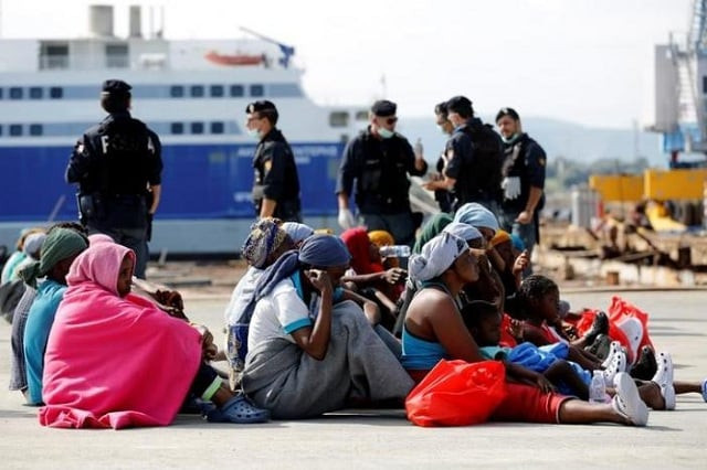 migrants rests after disembarking from dignity ship in the sicilian harbour of augusta italy photo reuters migrants rests after disembarking from dignity ship in the sicilian harbour of augusta italy photo reuters
