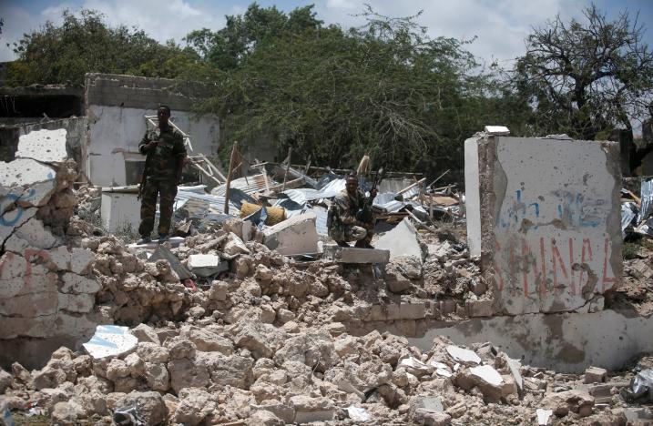 security forces stand guard on a destroyed building following a car bomb claimed by al shabaab militants outside the president 039 s palace in the somali capital of mogadishu august 30 2016 photo reuters