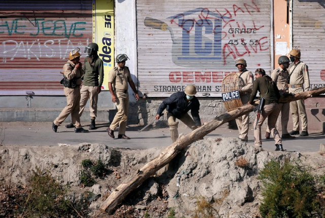 indian policemen remove a blockade setup by kashmiri protesters in front of closed shops during an anti india protest in srinagar october 14 2016 photo reuters indian policemen remove a blockade setup by kashmiri protesters in front of closed shops during an anti india protest in srinagar october 14 2016 photo reuters