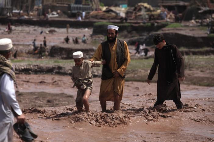 residents use a bridge covered with floodwater after heavy rain in nowshera district on the outskirts of peshawar pakistan april 4 2016 photo reuters