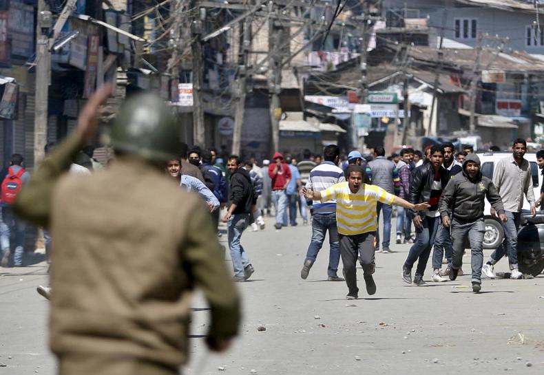 kashmiri protesters run towards indian security personnel during a demonstration against the plan to resettle hindus in srinagar photo reuters