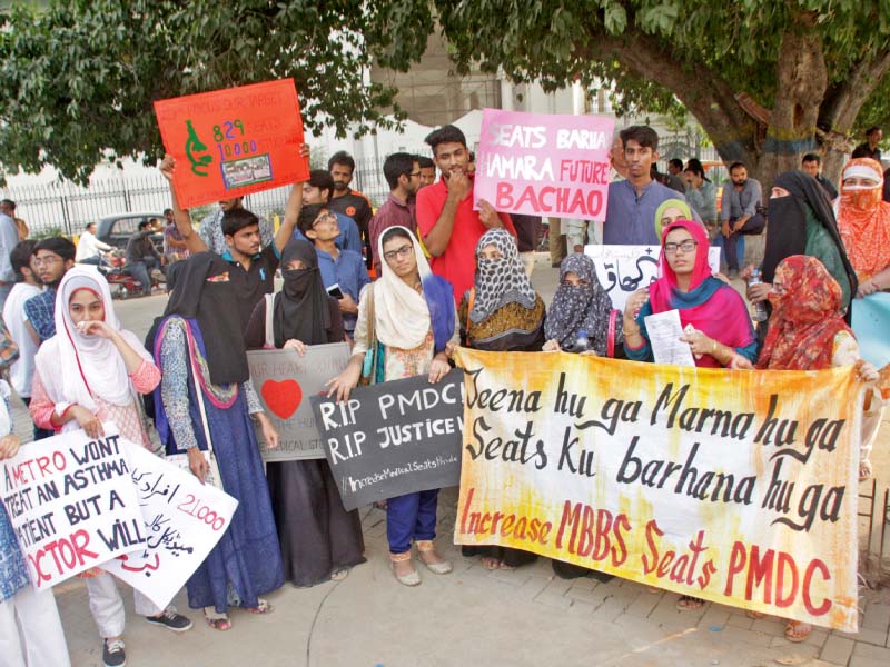 students hold placards and banners in support of their demands of increasing the number of seat for public medical colleges photo abid nawaz express