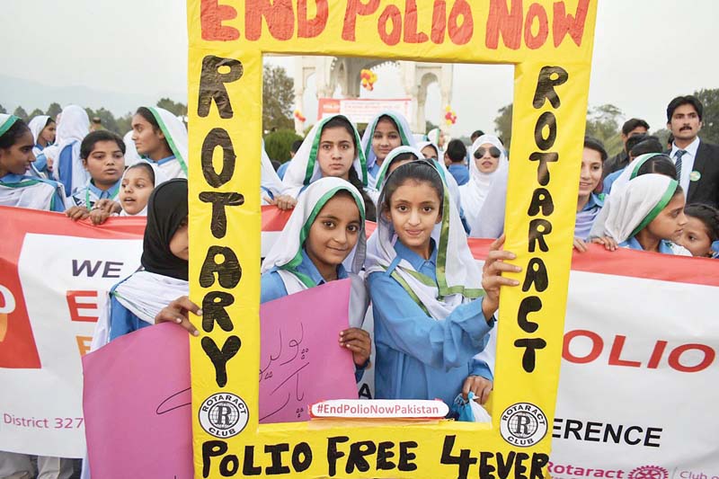 schoolgirls hold placards and posters during a walk held at the fatima jinnah park to create awareness about eradication polio from pakistan photo online