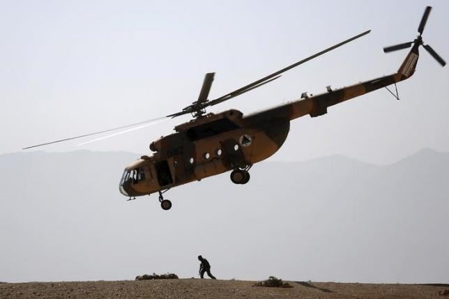 an afghan national army ana helicopter flies over a soldier during a training exercise at the kabul military training centre photo reuters