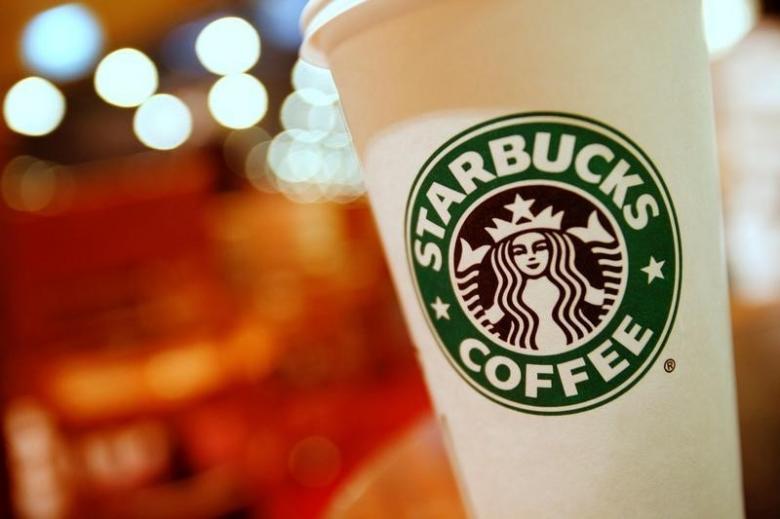 a cup of starbucks coffee sits on a table in a cafe in central hong kong january 16 2011 photo reuters