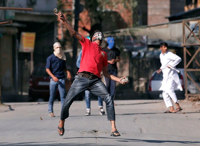 a kashmiri demonstrator hurls a stone at indian policemen during an anti india protest in srinagar october 14 2016 photo reuters
