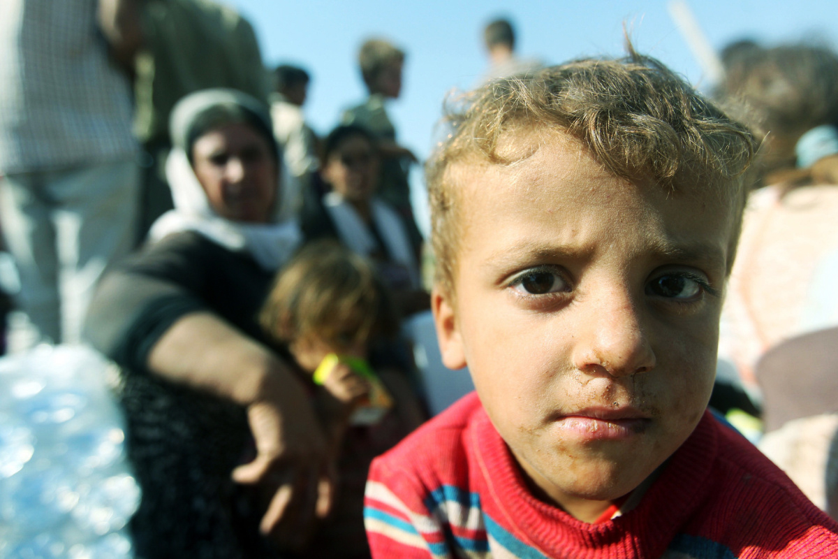 a displaced iraqi child from the yazidi community rests after crossing the syrian iraqi border at the fishkhabur crossing in northern iraq on august 13 2014 photo afp