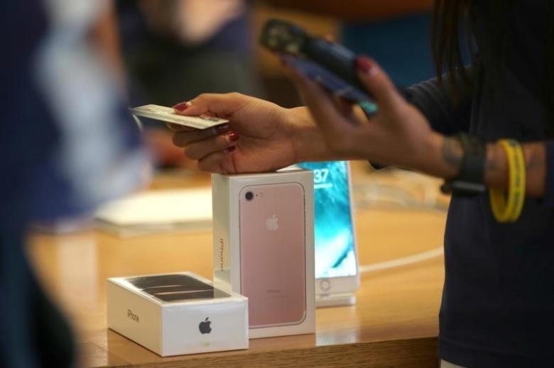 a customer buys the new iphone 7 smartphone inside an apple inc store in los angeles california u s september 16 2016 photo reuters