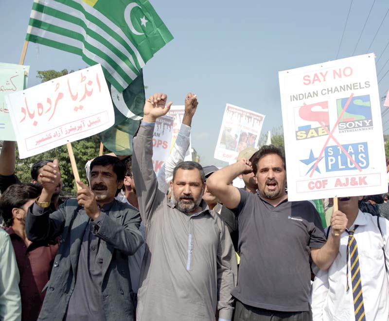 kashmiri people including cable tv operators shout anti india slogans at a protest in muzaffarabad on wednesday held to support a ban on indian tv channels photo afp