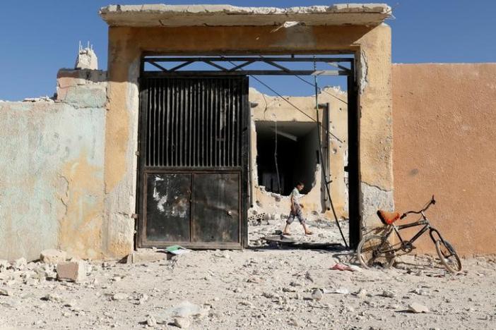 a boy inspects a damaged site after shelling in the rebel held town of hass south of idlib province syria october 26 2016 photo reuters