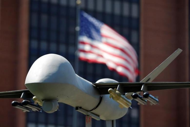 a model of a military drone is seen in front of an us flag as protesters rally against climate change ahead of the democratic national convention in philadelphia pennsylvania us july 24 2016 photo reuters