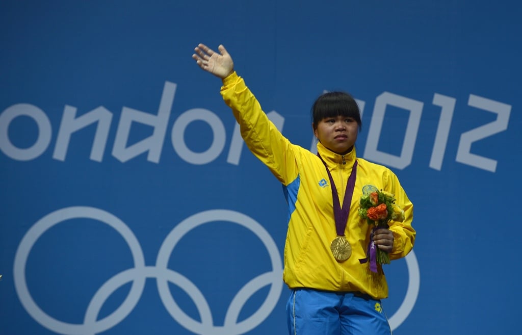 zulfiya chinshanlo celebrating on the podium after winning the weightlifting women 039 s 53kg group a during the 2012 london olympic games photo afp