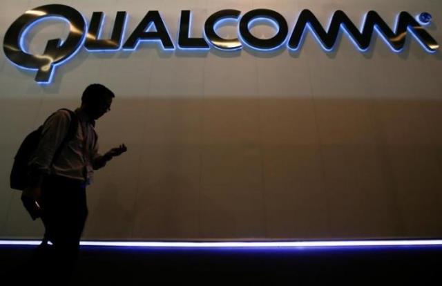 a man walks past qualcomm stand while attending the mobile world congress in barcelona march 3 2015 photo reuters