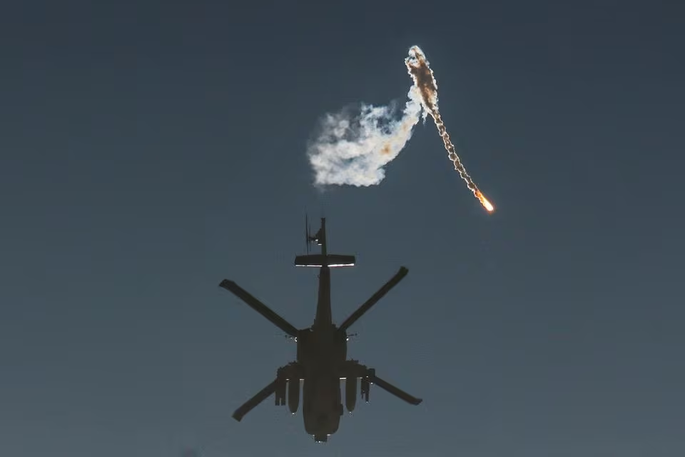 an israeli military helicopter releases a flare over the israel gaza border after a temporary truce between israel and the palestinian group hamas expired as seen from southern israel photo reuters