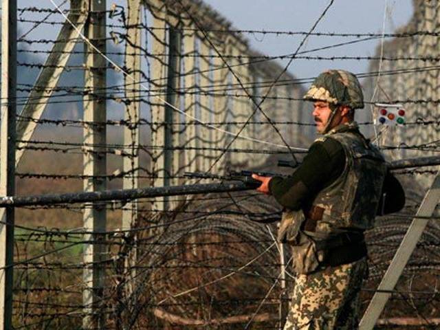 a soldier stands on guard along the line of control photo file