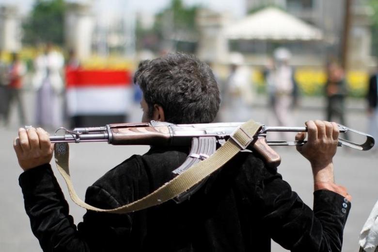 an armed man loyal to the houthi movement holds his weapon as he gathers to protest against the saudi backed exiled government deciding to cut off the yemeni central bank from the outside world in the capital sanaa yemen photo reuters