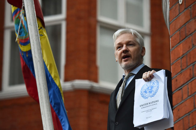 this file photo taken on february 5 2016 shows wikileaks founder julian assange addressing the media holding a printed report of the judgement of the un 039 s working group on arbitrary detention on his case from the balcony of the ecuadorian embassy in central london photo afp