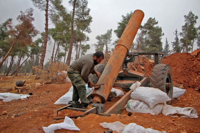 rebel fighters from the jaish al fatah or army of conquest prepare to fire a home made mortar launcher during a major offensive against regime forces near aleppo on october 28 2016 photo afp
