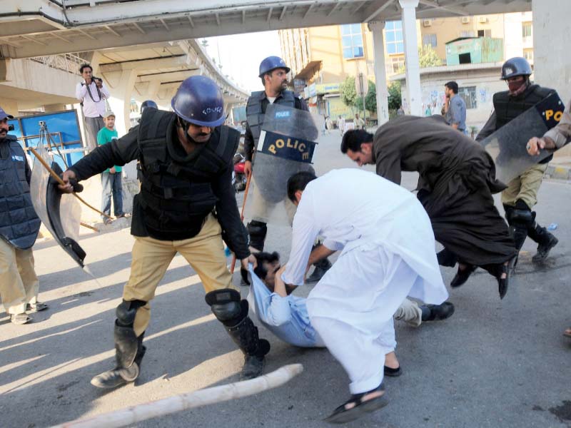 police in uniform and civvies drag a awami muslim league worker in rawalpindi on friday photo afp