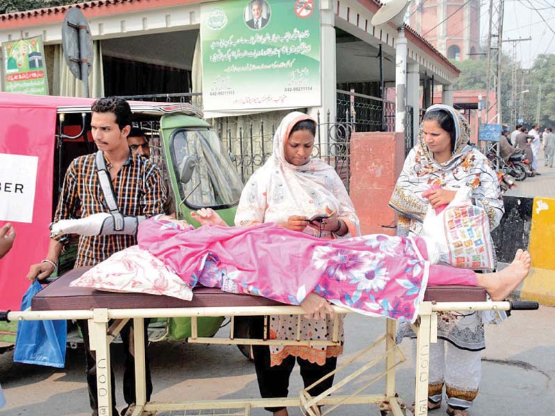 a patient and her family wait for doctors outside mayo hospital photo online