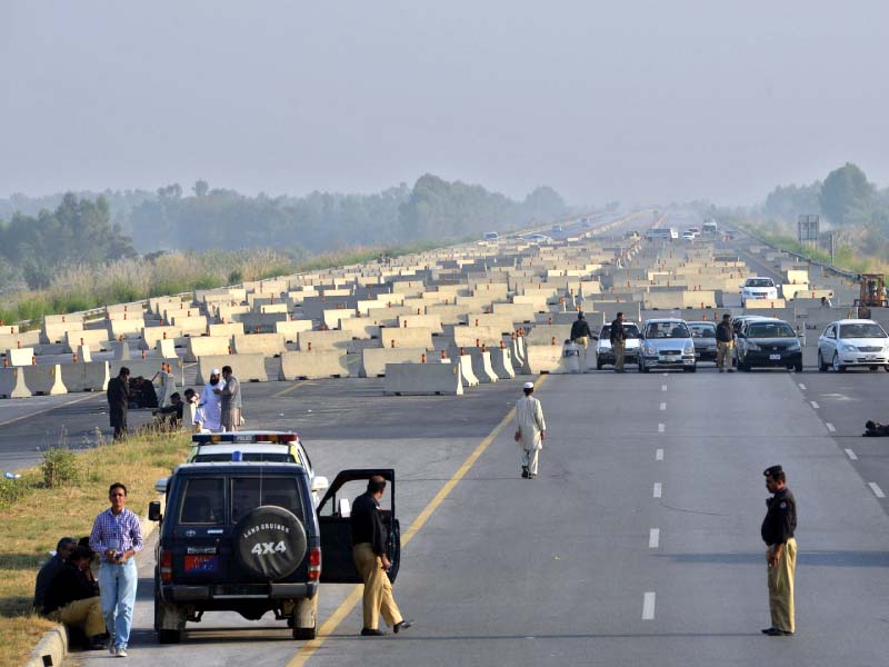 policemen stand at the roadblock on the motorway in swabi photo afp