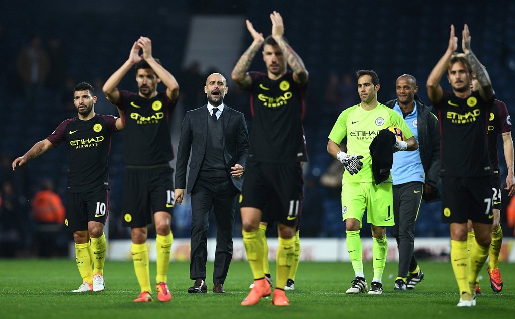 pep guardiola c celebrates on the pitch with his players in west bromwich england on october 29 2016 photo afp