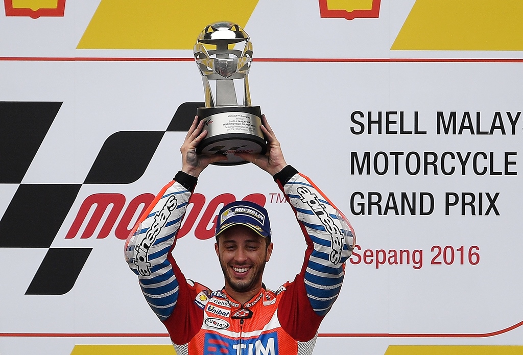 andrea dovizioso celebrates on the podium at the sepang international circuit on october 30 2016 photo afp